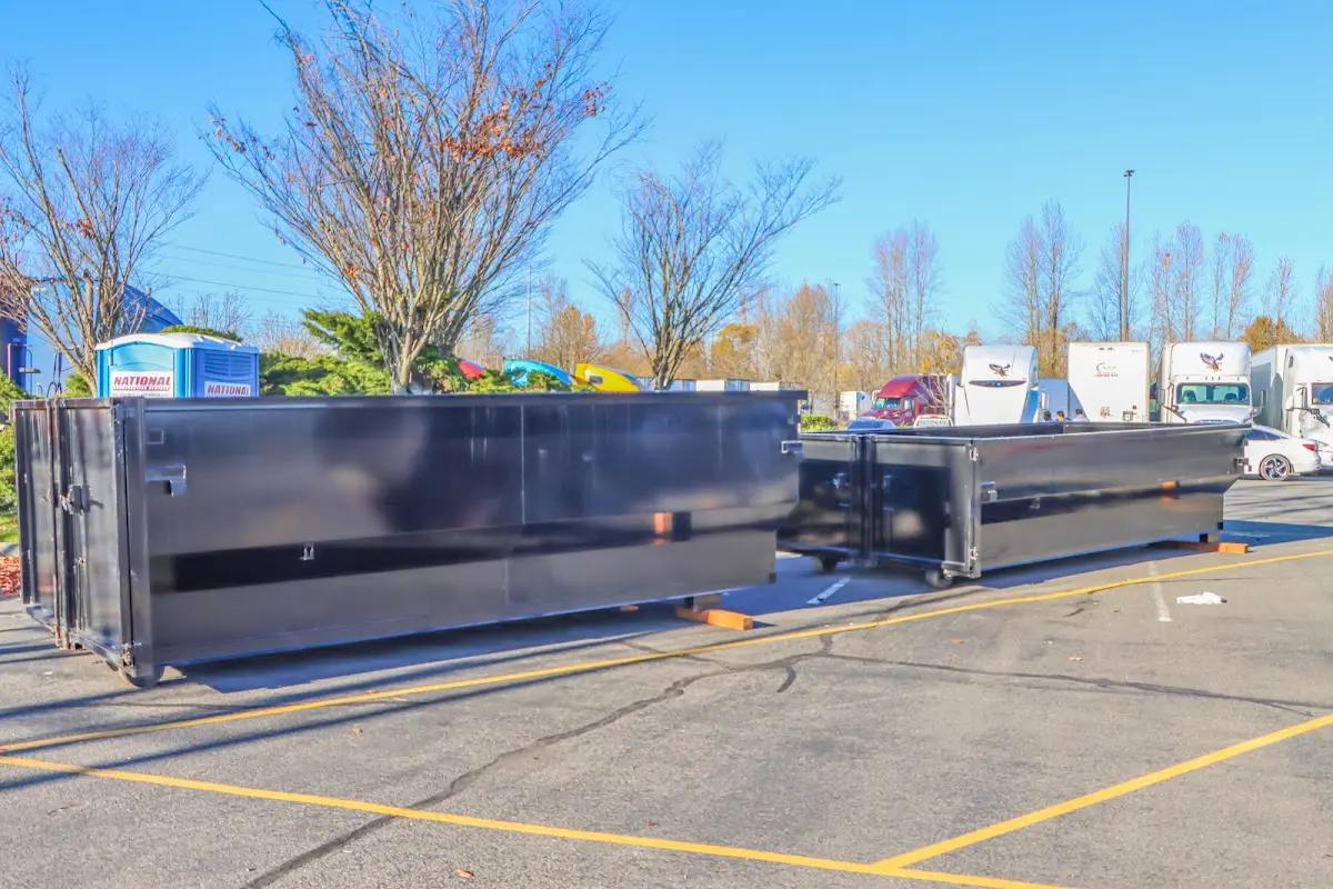 Professional dumpster rental service with roll-off container on residential driveway in Gibsonville